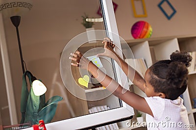 Placing a sticky note on a window Stock Photo