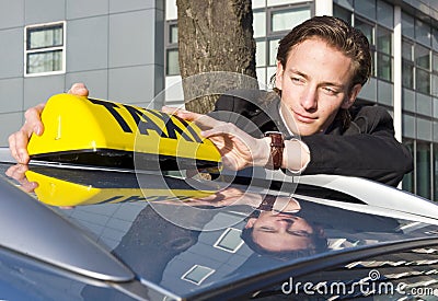 Placing the Taxi sign Stock Photo