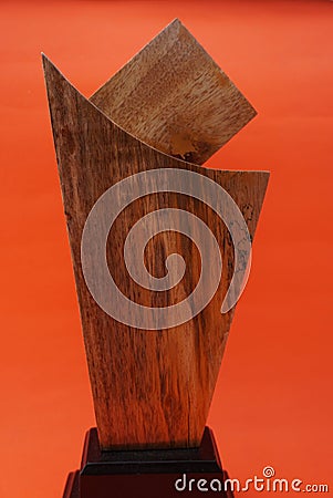 A plain award plaque made of wood on an orange background and used as a keepsake. Suitable for Awards, trophies, certificates, web Stock Photo