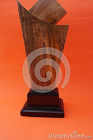 A plain award plaque made of wood on an orange background and used as a keepsake. Suitable for Awards, trophies, certificates, web Stock Photo