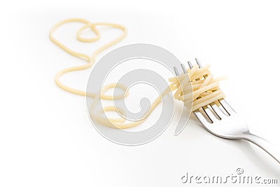 Plain cooked spaghetti pasta on fork with heart shape, on white background. Stock Photo