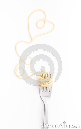 Plain cooked spaghetti pasta on fork with heart shape, on white background. Stock Photo