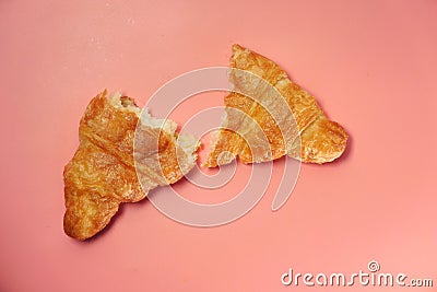 Plain half croissant on pink background, top down Stock Photo