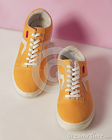 Plain yellow converse sneakers isolated on a bright background Stock Photo