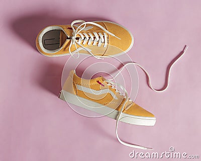 Plain yellow converse sneakers isolated on a bright background Stock Photo