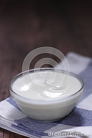 Plain yogurt in small glass bowl Stock Photo