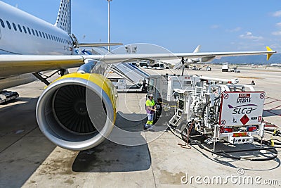 Plaine receiving fuel from tanker truck Editorial Stock Photo