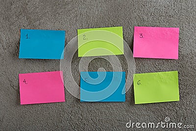 Plan of the week on colored blank stickers on concrete wall Stock Photo