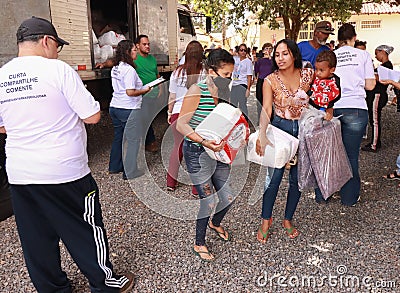 Poor people mostly women receiving food and other goods called Cesta Basic Editorial Stock Photo