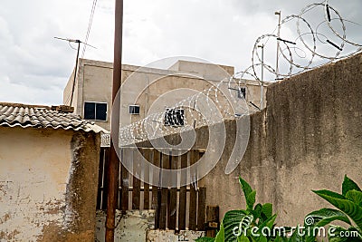 Barbwire atop a fence for extra protection Editorial Stock Photo