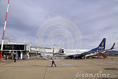 The plane of Bolivian Airlines with a sleeve in airport Editorial Stock Photo