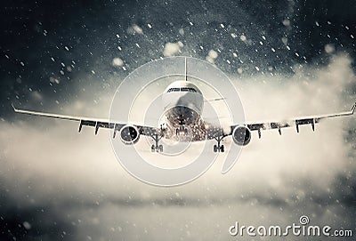 Plane landing in difficult meteorological conditions during snowfall. Created with Generative AI technology Stock Photo