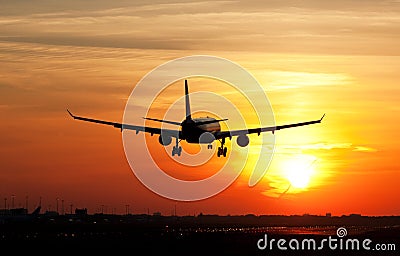 Plane landing in sunrise Stock Photo