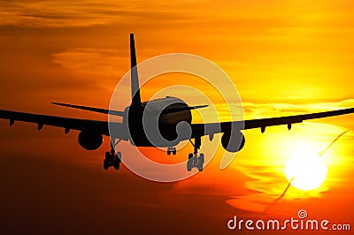 Plane landing in sunrise Stock Photo