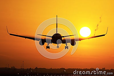 Plane landing in sunrise Stock Photo