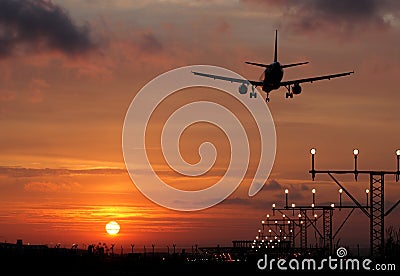 Plane landing in a sunset Stock Photo