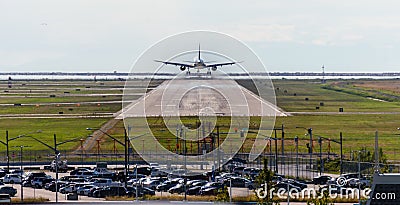 The plane makes landing on the runway at day time Stock Photo