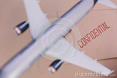 The Plane Model Over The Confidential Brown Envelop Stock Photo