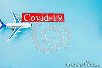 Plane model toy and COVID-19 text concept. Flight cancellation due to the impact of coronavirus Stock Photo
