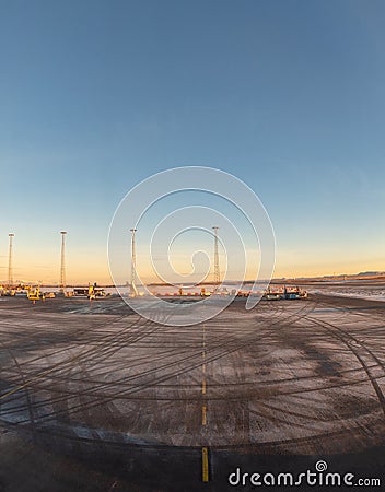 Plane runway covered with ice, vehicle track marks Stock Photo