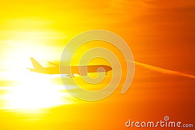 Silhouette of airplane in the orange sky Stock Photo