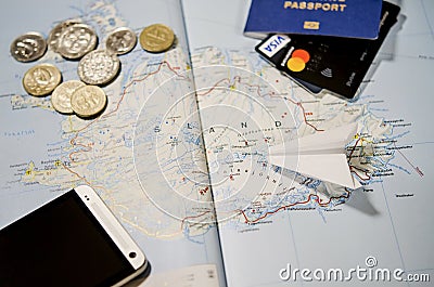 The plane, smartphone, biometric passport, dollars, coins and credit cards lie on a map Editorial Stock Photo