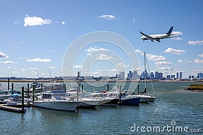 New England Marina with Plane Overhead Editorial Stock Photo