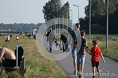 Plane spotter walking by Polderbaan runway, Amsterdam Airport Editorial Stock Photo