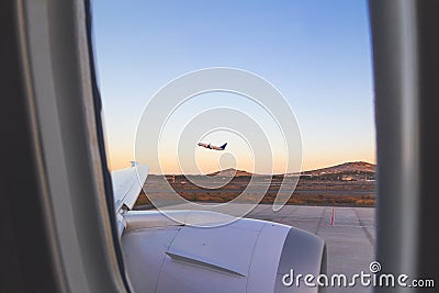 Plane taking off from the airport, seen from the window of the plane. Travel by plane concept Stock Photo