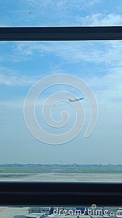 A plane viewed from window at the airport Editorial Stock Photo