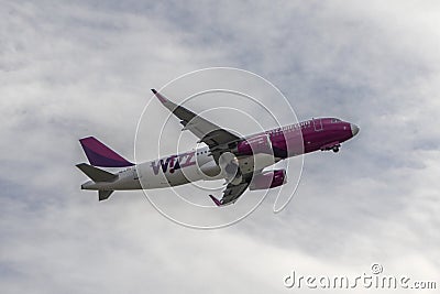 Plane Wizz Air in cloudy sky Editorial Stock Photo