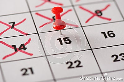 Planed meeting is here concept. Cropped close up view photo of red pushpin attached to calendar with date 15th with crossed Stock Photo