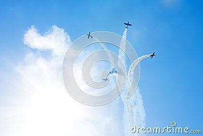 Planes fly scatter in the form of a fountain in the sky leaving a trail of clouds behind them trail Stock Photo