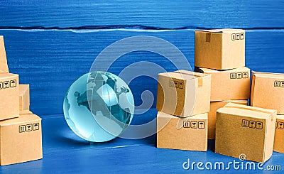 Planet Earth globe and cardboard boxes mass consumption products. Delivering goods around the world. International trade and Stock Photo