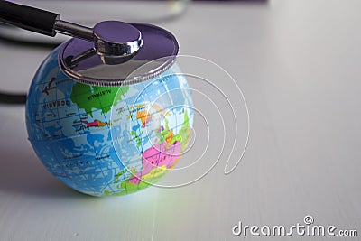 Planet earth and stethoscope. Global healthcare concept Stock Photo