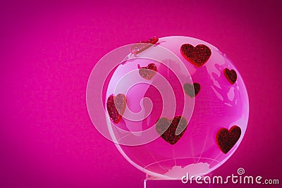 The planet of love. Glass globe with red hearts. Stock Photo