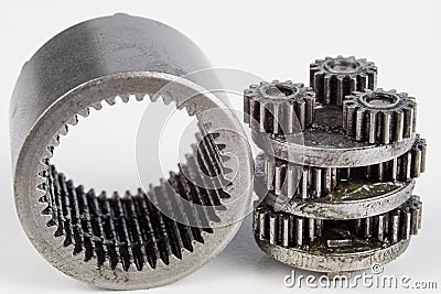 Planetary gear from a small device on a bright table. Gear wheel Stock Photo