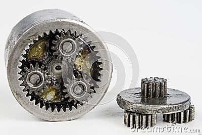 Planetary gear from a small device on a bright table. Gear wheel Stock Photo