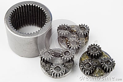 Planetary gear from a small device on a bright table. Gear wheel Stock Photo