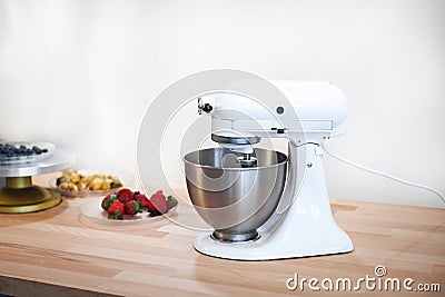 Planetary mixer on a table with fruit on a white background Stock Photo