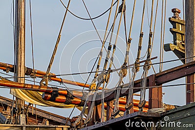 Planks, ropes, pulleys, tackle, and rigging of a replica of an old 1400's era sailing ship Stock Photo