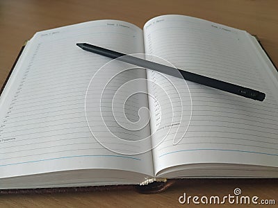 Daily planner and pencil, plans for the day Stock Photo