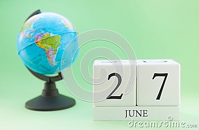 Planner wooden cube with numbers, 27 day of the month of June, summer Stock Photo