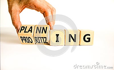 Planning and prioritizing symbol. Concept words Planning and Prioritizing on wooden cubes. Businessman hand. Beautiful white Stock Photo