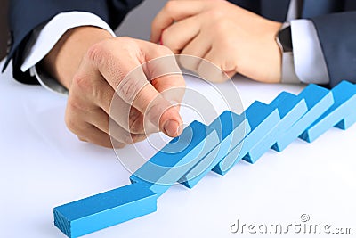 Planning, risk and strategy in business, businessman pushing wooden block Stock Photo