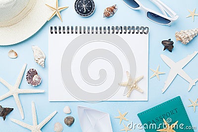 Planning summer holidays, tourism and vacation background. Travelers notebook with accessories on blue desk top view. Flat lay. Stock Photo