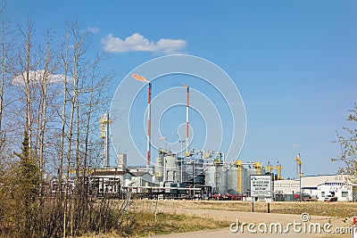 A plant with flaming smokestacks in northern canada Editorial Stock Photo