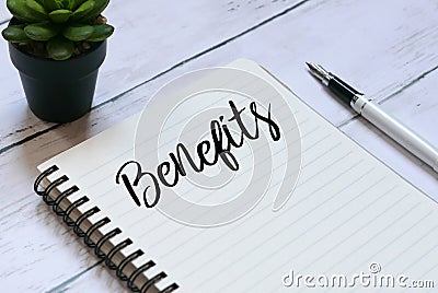 Plant,pen and notebook written with word Benefits on white wooden background. Stock Photo