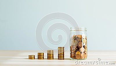Plant on pile coins in the bottle, Money growing concept and the goal success. Stock Photo