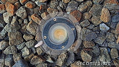 A planting lamp surrounded by pebbles Stock Photo